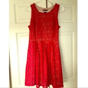Sleeveless red lace dress.